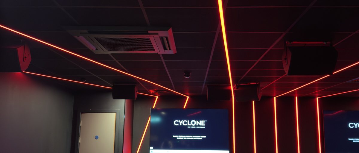 David Lloyd St Neots — black grid ceiling with feature lighting to the indoor cycling studio